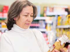 Woman looking at OTC bottle