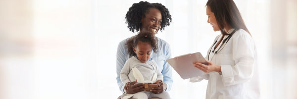 woman with child talking to doctor