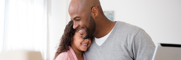 father hugging young daughter